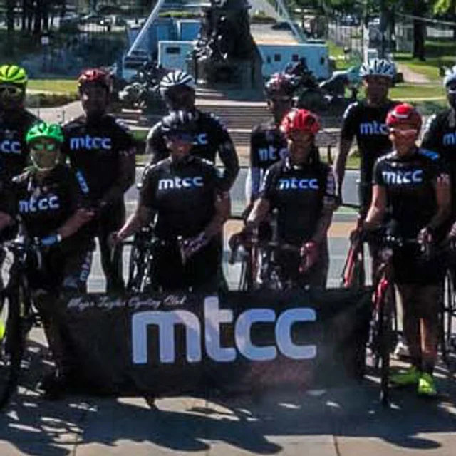 MTCC Philly riders in club kit behind the Major Taylor Cycling Club banner