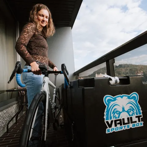 Erika Ackerlund on a hotel balcony with her road bike and Vault Pro
