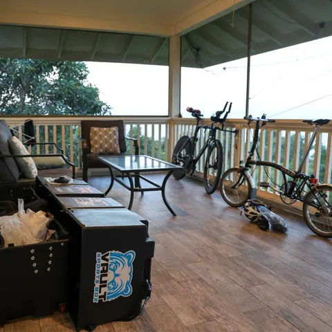 Kieran Lindars's Vault Pro unpacked on a veranda beside his time trial bike