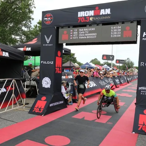 Rob Balucas finishing IRONMAN 70.3 Eagleman on his handcycle