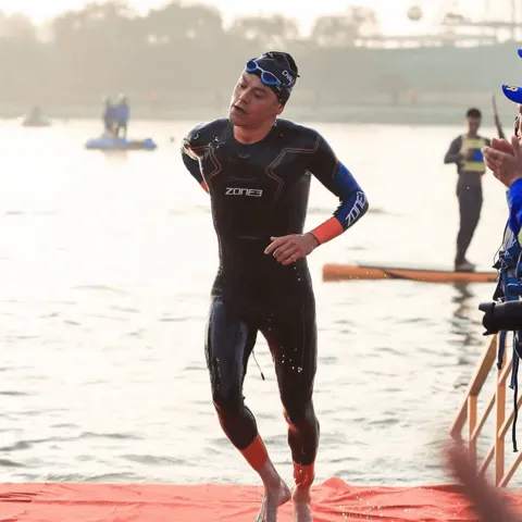 Thomas Davis running out of the water in his Zone3 wetsuit at Challenge Anhui