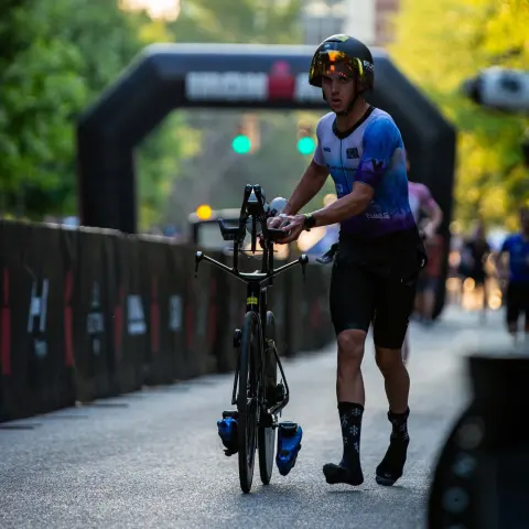 Thomas Inigo running his bike into transition