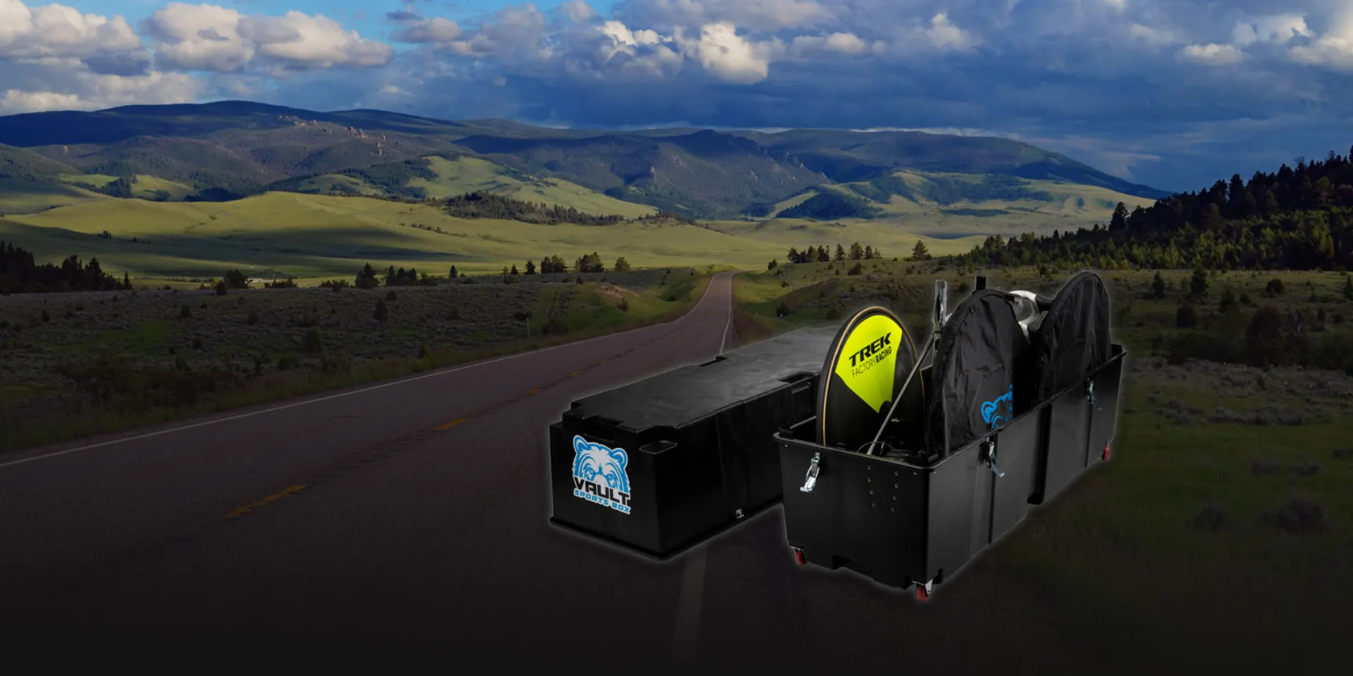 A Vault Pro bike box open on a Montana highway with the Northern Rockies behind it