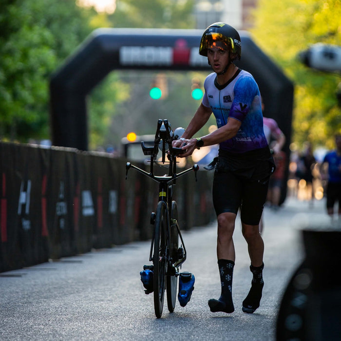 Thomas Inigo running his bike into transition
