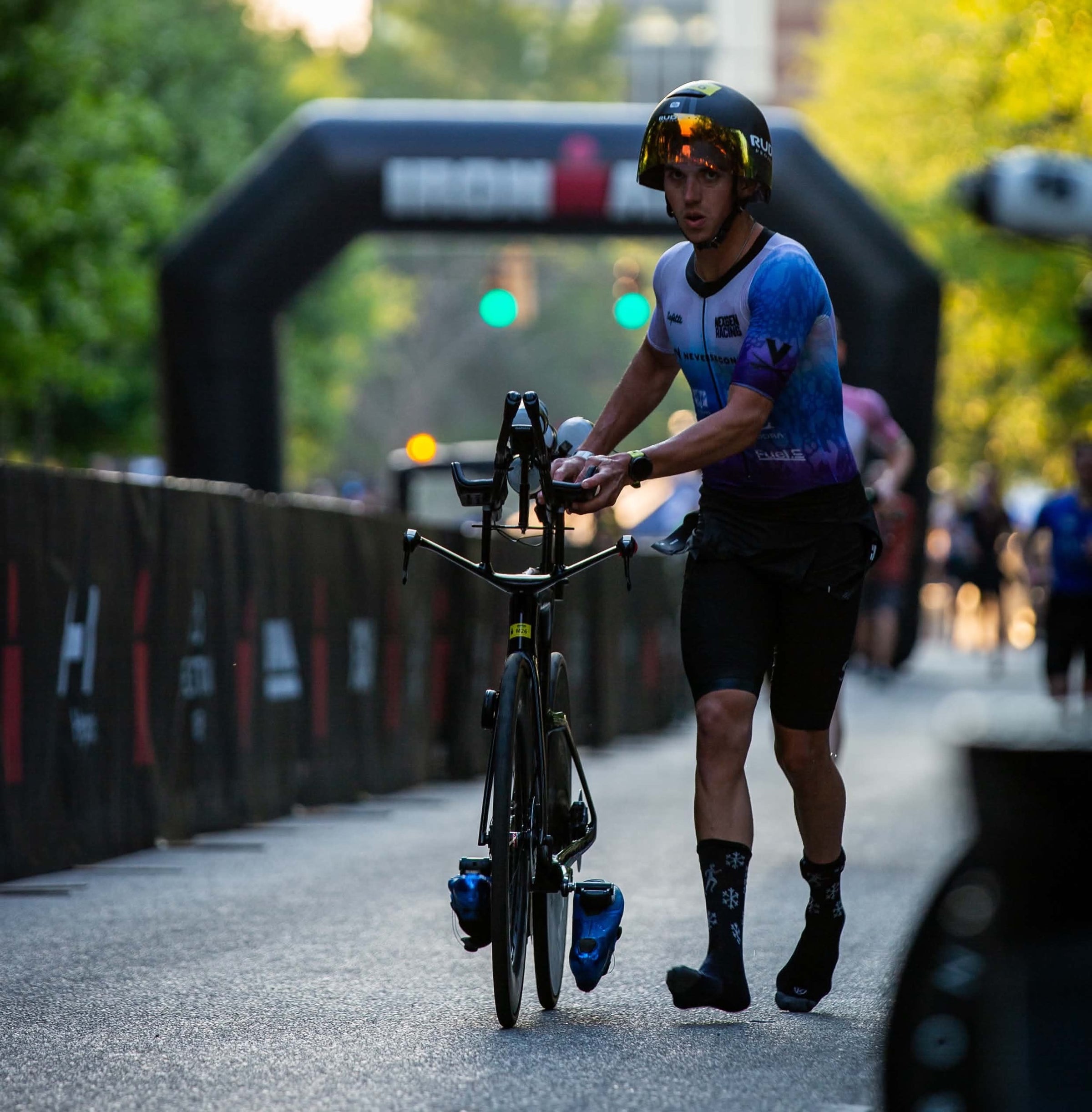 Thomas Inigo running his bike into transition